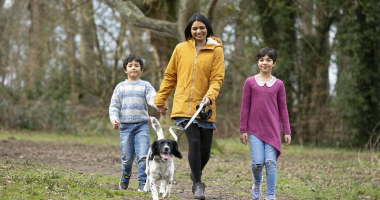 A family and their dog explore Kearsney Abbey park.