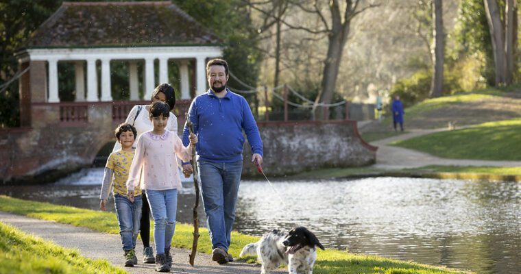 Family walk their dog at Russell Gardens.