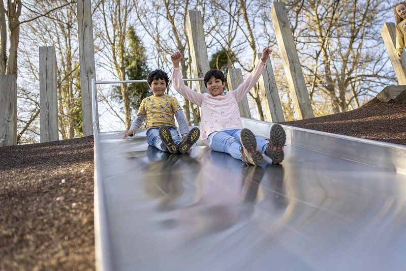 Brother and sister plays on the slide at Russell Gardens.