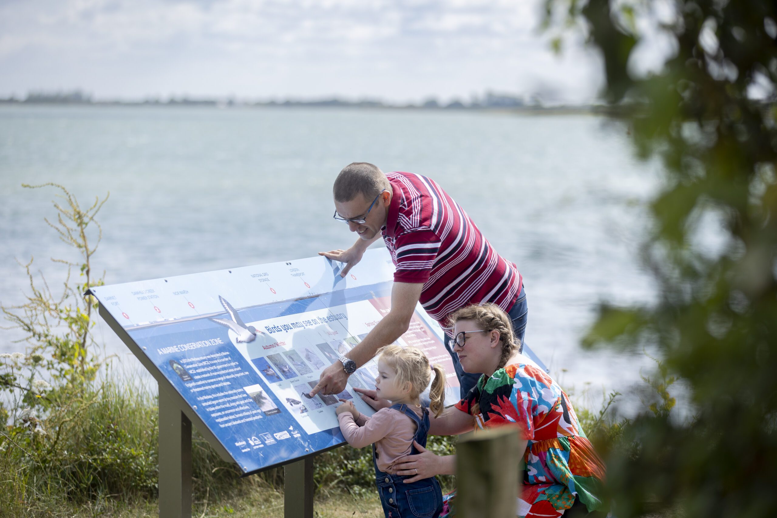 A family look at wildlife information boards in Riverside Country park