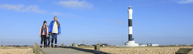 People walking near Dungeness lighthouse