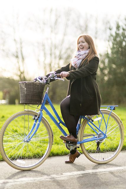 Happy woman sitting on bike