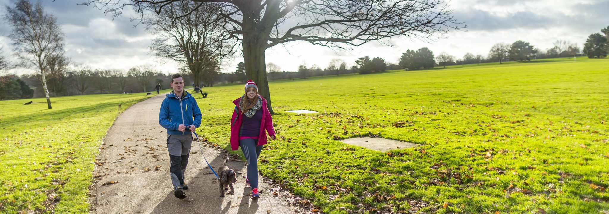 Two People walking dog in Mote Park