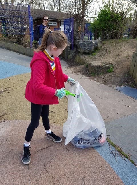 Child picking up rubbish