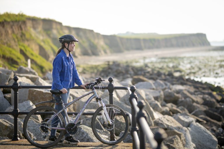 Girl and bike at Reculver Towers