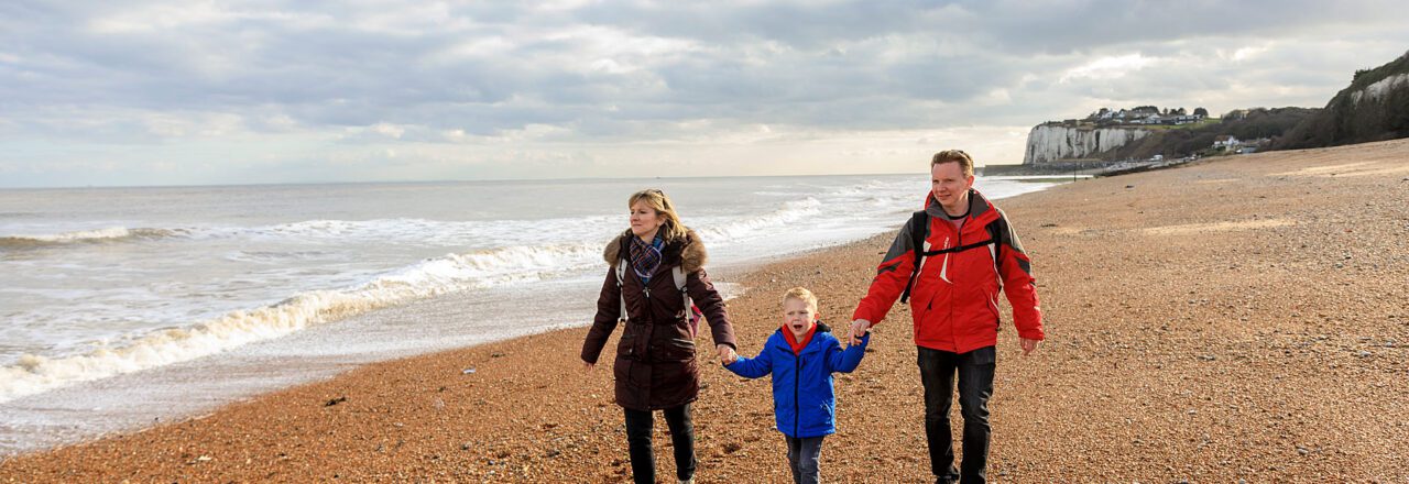 family walk on the beach