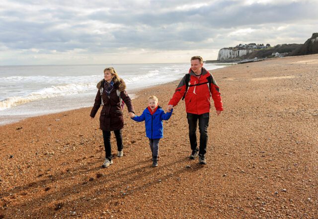 family walk on the beach