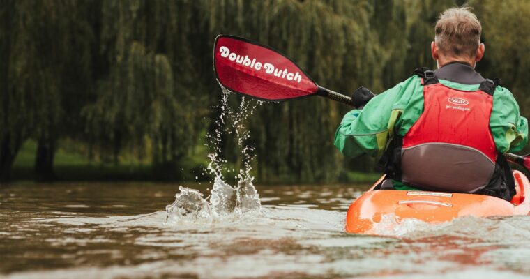 Man kayaking on a river.