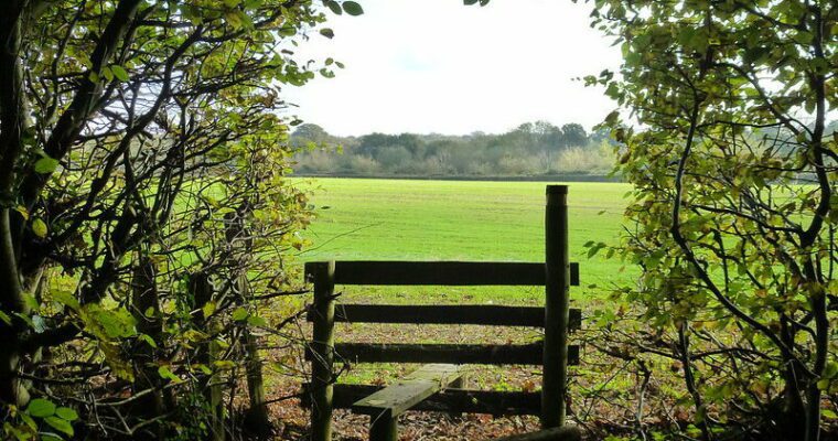 a stile and open field.