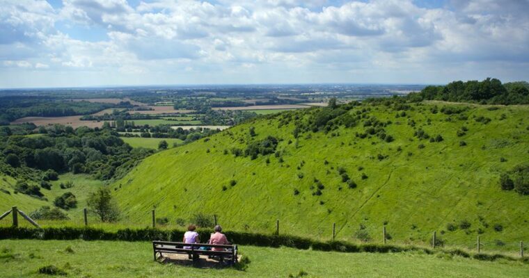 Walkers sitting on a bench enjoying view of kneading trough