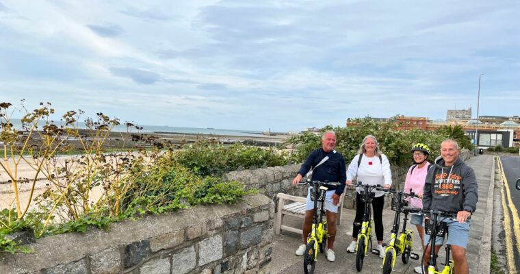 Group of people on E Bikes at the seafront