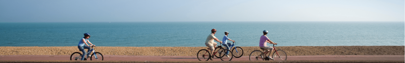 Cyclists cycling along Hythe seafront