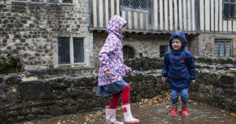 Children playing in the rain outside at Ightham Mote, Kent