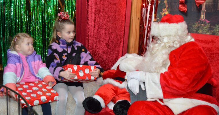 Image of two children with Santa