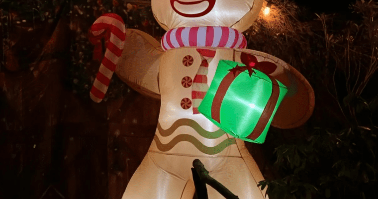 Inflatable gingerbread man holding a candy cane