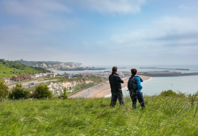 2 people looking out to sea on a cliff top