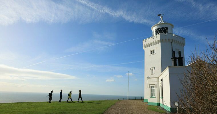 White Cliffs of Dover lighthouse with a group of people walking past