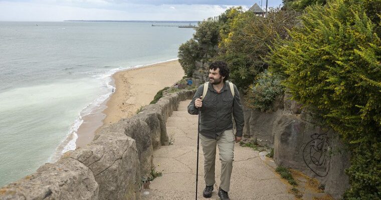 A man walking up the stone steps