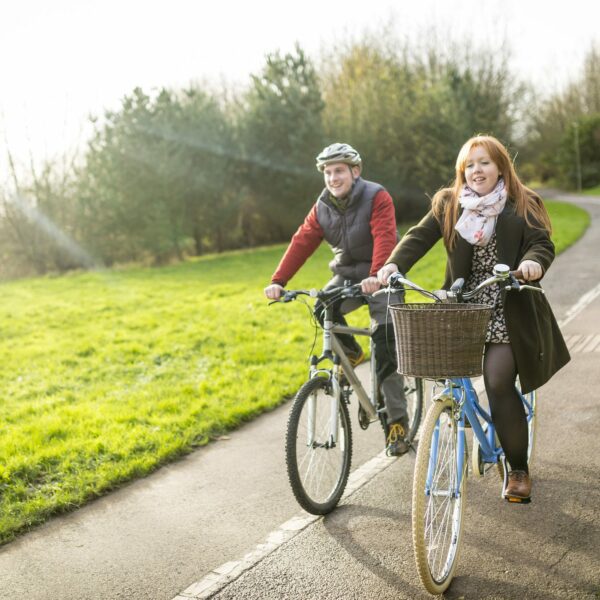 Image of two people cycling on a cycle path.