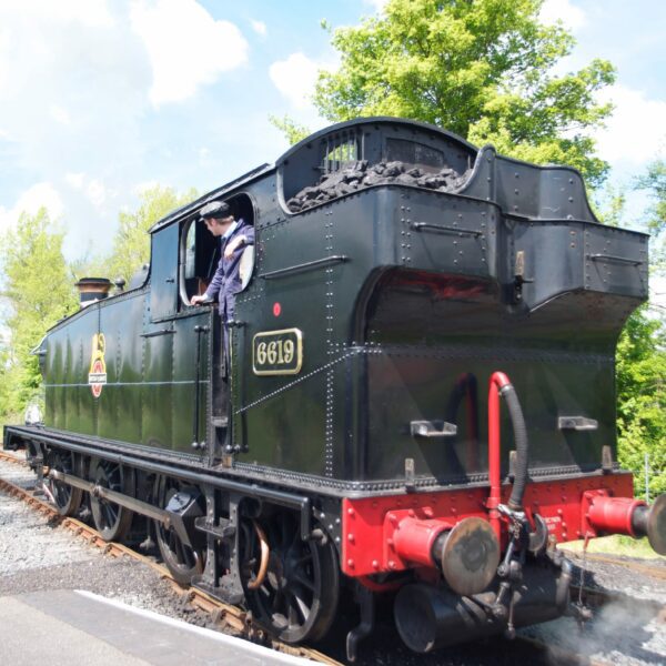 Black Steam train on railway tracks, Kent & East Sussex Railway (K&ESR) in Tenterden