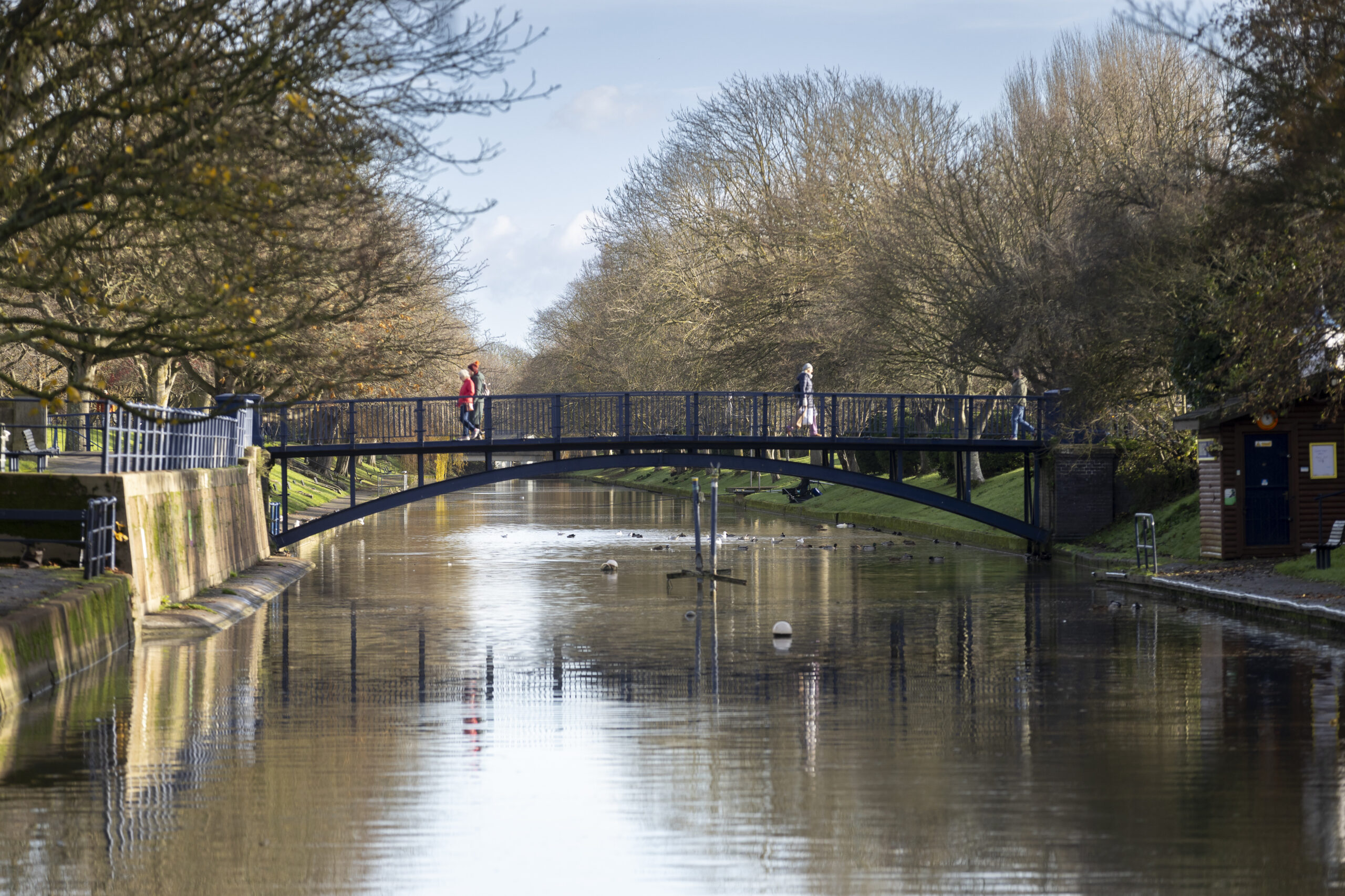 A bridge crossing the canal with people walking across