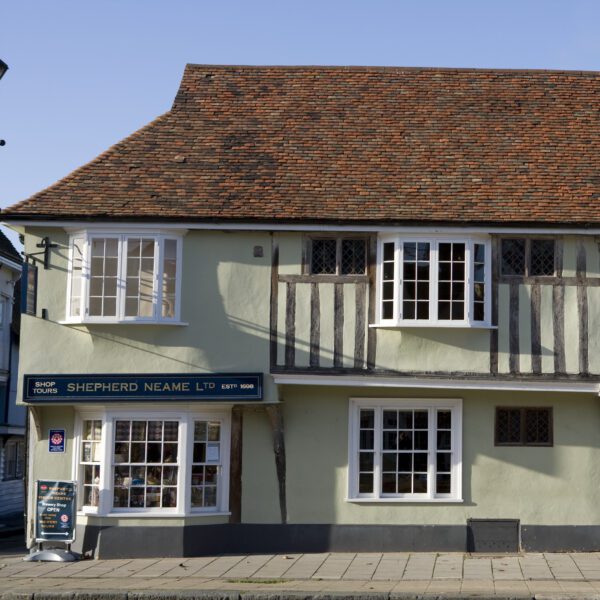 Outside of the Shepherd Neame building with a blue sign for the shop and tours.