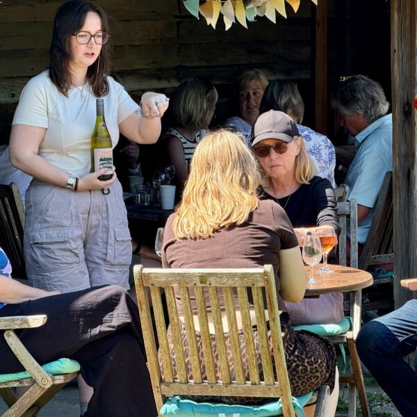 People at a table taking part in a wine tasting experience.