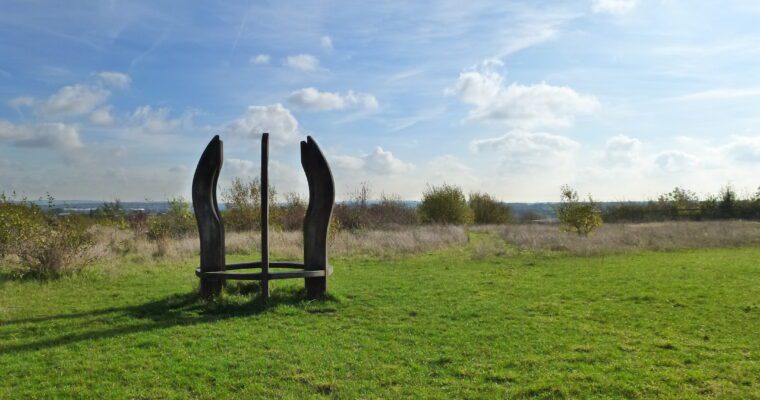 Wooden sculpture on grass field