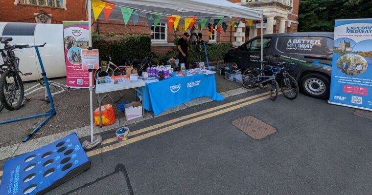 Bike mechanic at work in a stand with promotional material for A Better Medway